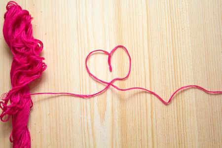 embroidery floss on wooden background. handmade conceptの写真素材