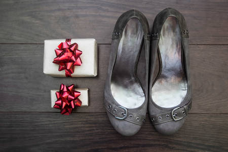 shoes and gifts on a background of dark parquet, a gift conceptの写真素材