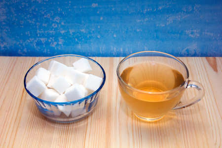 glass mug with tea and a glass sugar bowlの写真素材