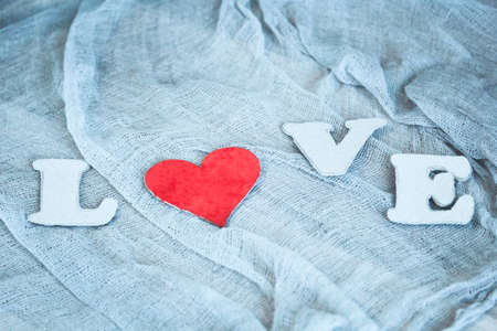background in light  muted retro colours:letters L,O,V,E and red heart. concept for st.Valentine's dayの写真素材
