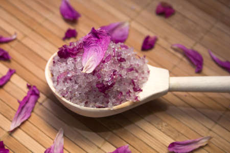 homemade body scrub from sea salt and rose petals and peony on a straw Mat. Spa conceptの写真素材