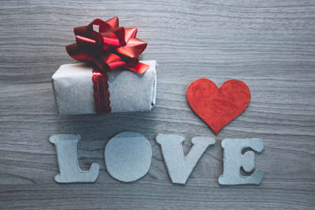 LOVE letters, cardboard heart and gift  box  with red bow. concept for Valentine's day, romantic anniversary,love.の写真素材