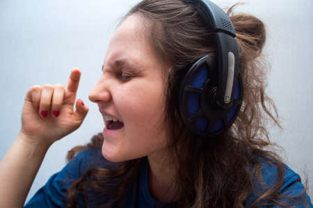 Girl with headphones singing  her favorite songの写真素材