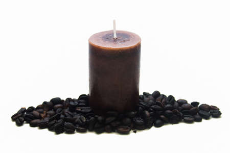 Candle and coffee beans on white backgroundの写真素材