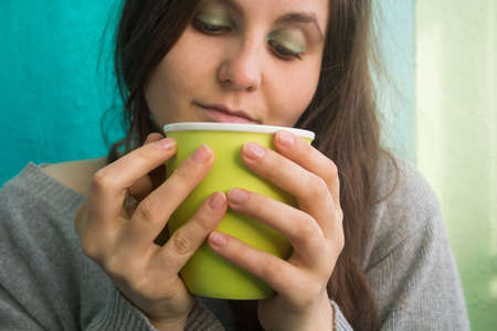 young beautiful girl holding a Cup of tea / coffeeの写真素材