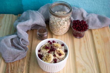 oatmeal with fresh banana slices, cranberries and flax seedの写真素材