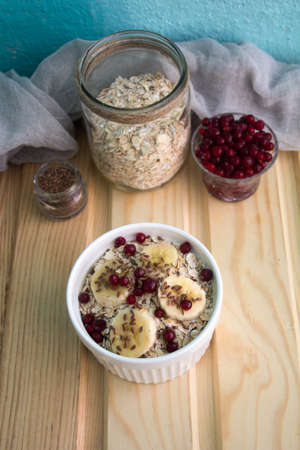 oatmeal with fresh banana slices, cranberries and flax seedの写真素材
