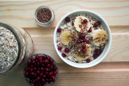 oatmeal with fresh banana slices, cranberries and flax seedの写真素材
