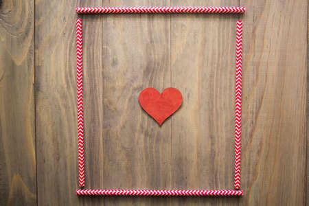 mock up background with cocktail straws and a heart on wooden backgroundの写真素材