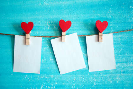 white sheet of paper on the clothespin with heartsの写真素材