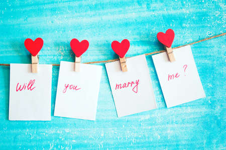 offer hands and hearts on the clothespin with heartsの写真素材