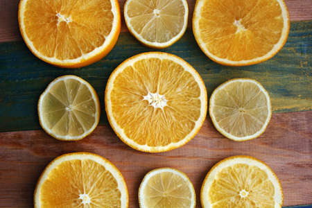 slices of lemon and orange on a wooden tableの写真素材
