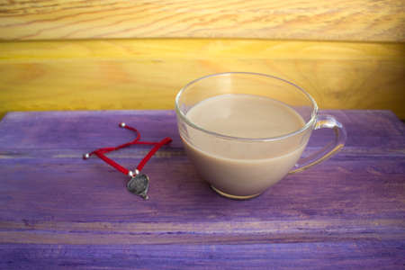 coffee with cream and red string braceletの写真素材