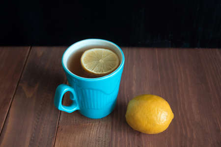 lemon tea in  blue cups on a wooden table