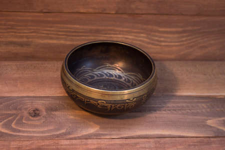 singing bowl on wooden backgroundの写真素材