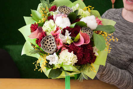 florist girl holding a bouquet of mix flowersの写真素材