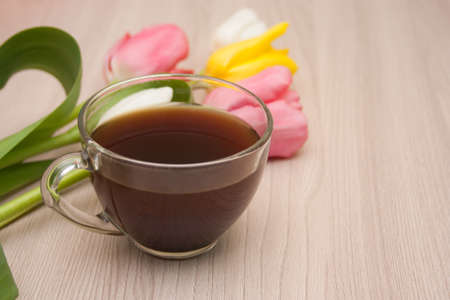 black coffee and tulips on the table, empty copyspace.の写真素材