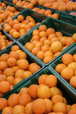 fresh oranges in boxes on the market