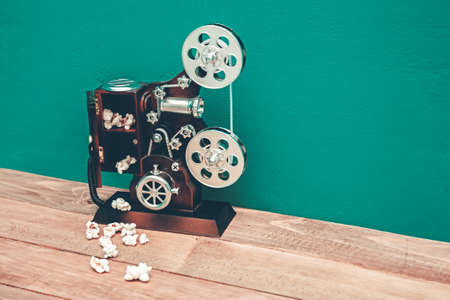 vintage music box in the shape of an old movie camera  and popcorn. retro tones. copy spaceの写真素材