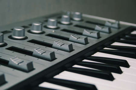 Midi keyboard close-up, keys and fadersの写真素材