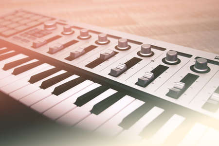 Midi keyboard close-up, keys and faders. Tonedの写真素材