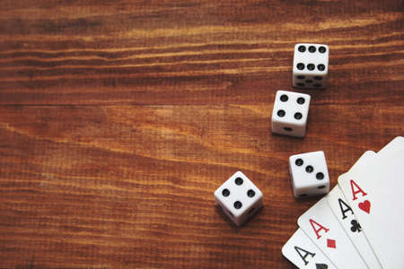 cards and dice on a wooden background