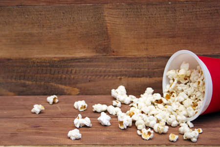 Popcorn bucket on a wooden backgroundの写真素材