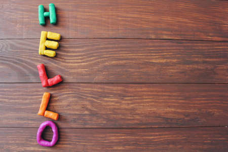 letters H, E, L, L, O on wooden backgroundの写真素材