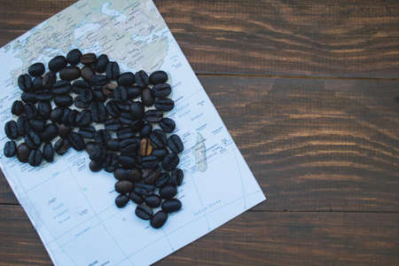 map of Africa and coffee beans on wooden table, top viewの写真素材
