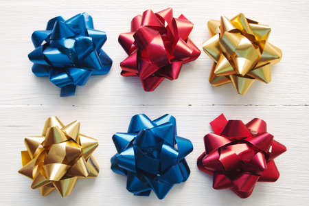 festive bows pattern on white wooden background, top view, flat layの写真素材