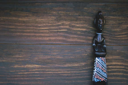 African figurines on wooden background.の写真素材