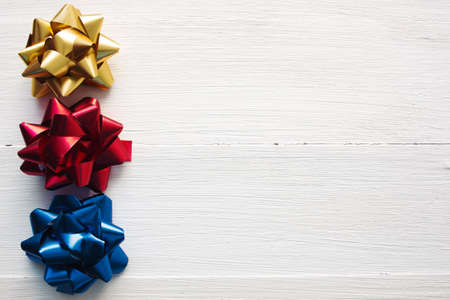 festive bows on white wooden backgroundの写真素材