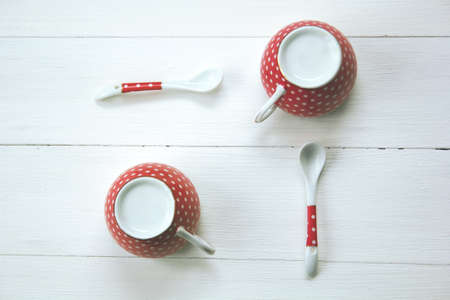 polka dot cups and spoons  on a white background. retro tonedの写真素材