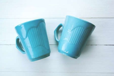 blue cups on a white background. retro toned photoの写真素材