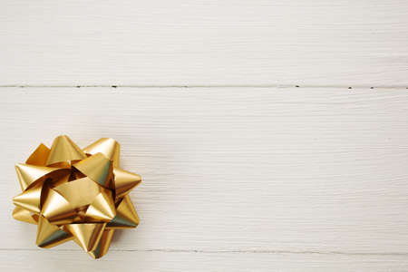 festive bow on white wooden background, top viewの写真素材