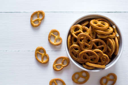 Pretzel snacks in a porcelain bowl over white backgroundの写真素材