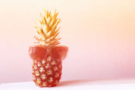 funny pineapple with glasses. toned photo. copy space.の写真素材