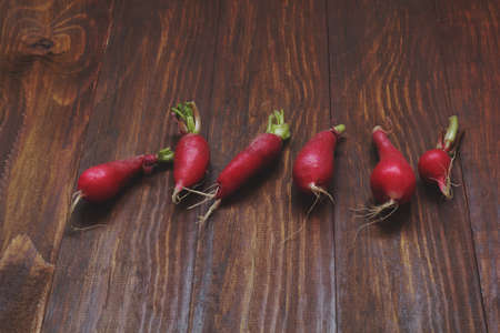 fresh radishes on a wooden tableの写真素材
