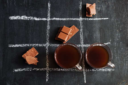 TIC TAC toe with coffee and chocolate.top view.の写真素材
