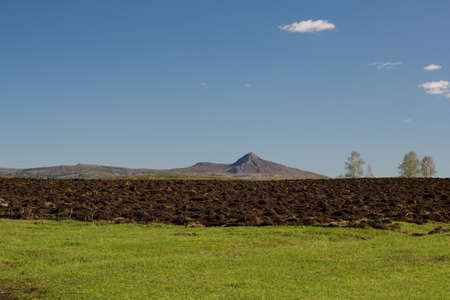 landscape with mountain and tilled groundの写真素材