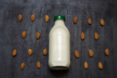 top view bottle of fresh raw vegan almond  milk on a black backgroundの写真素材