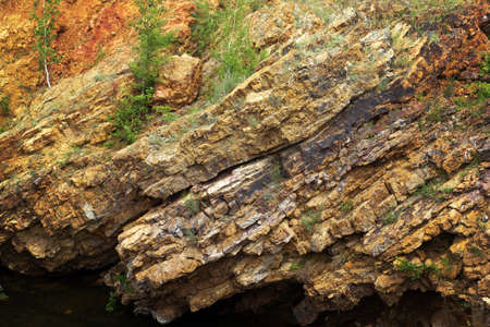 part of the rock with  trees over the lakeの写真素材