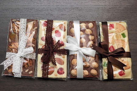 tiles of  homemade milk and white chocolate on dark wooden background