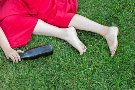 drunk girl sleeping in the park after the party. the problem of female alcoholism.の写真素材