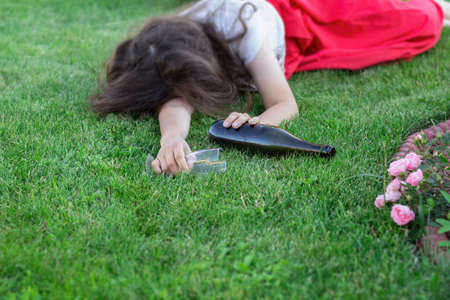 drunk girl sleeping in the park after the party. the problem of female alcoholism.の写真素材