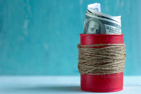 dollars in the red jar on the table. copy space. save money concept.の写真素材