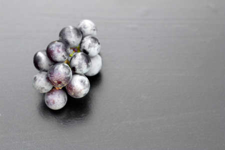 bunch of grapes on a dark background, top viewの写真素材