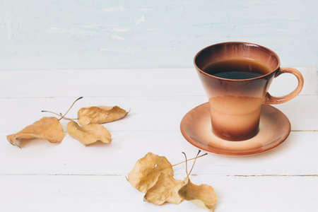 Cup of black coffee and autumn leavesの写真素材