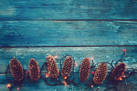 pine cones and garland on a blue wooden backgroundの写真素材