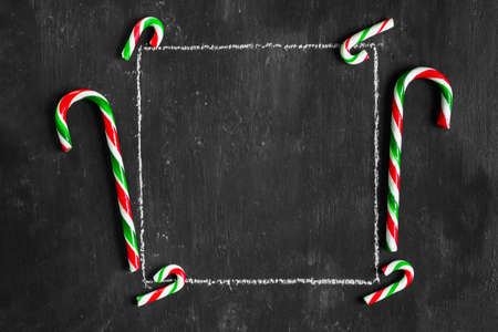 square frame on the chalk board with candy canes